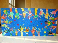 this is an image of handprints on a blue board with stars and hearts