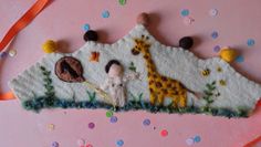 this is a handmade ornament with a giraffe and other animals on it