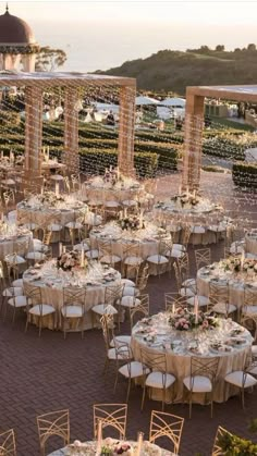 tables and chairs are set up for an outdoor wedding reception at the ocean side venue