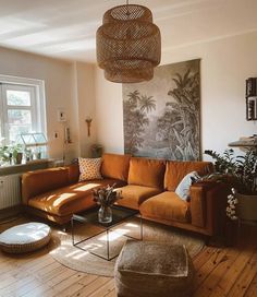 a living room filled with furniture and a large painting hanging on the wall above it