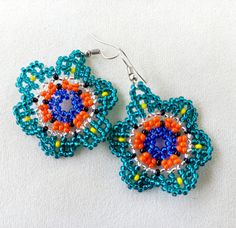 Native American tribal earrings made of beads in different shapes and forms with symbolism. See all kinds in my other listings. They fit every woman perfectly and really create a lovely look. I always get compliments on them! Handmade Bohemian Beaded Flower Earrings, Handmade Bohemian Flower-shaped Beaded Earrings, Handmade Round Bead Flower Earrings For Festivals, Bohemian Beaded Earrings In Flower Shape, Bohemian Beaded Earrings In Flower Shape For Gifts, Bohemian Beaded Round Flower Earrings, Bohemian Flower-shaped Earrings With Colorful Beads, Bohemian Flower-shaped Beaded Earrings For Gifts, Bohemian Flower-shaped Beaded Earrings