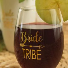 a close up of a wine glass with an apple