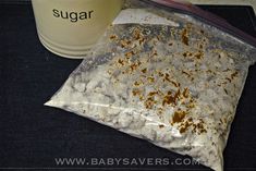 a bag of sugar next to a cup on a table