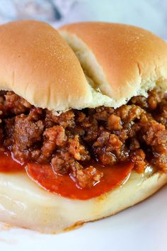 a sloppy joe sandwich with cheese and sauce