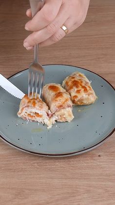 a person is cutting into some food on a plate with a knife and fork in it