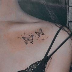 the back of a woman's shoulder with three butterflies on her left side,