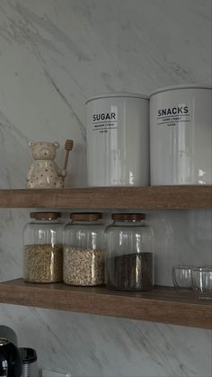 shelves with jars and glasses on them in a kitchen