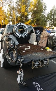 a truck is parked in a parking lot with other vehicles and decorations on the bed