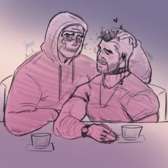 two people sitting at a table, one wearing a hoodie and the other with glasses