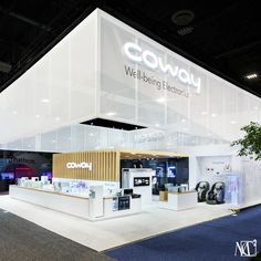 an exhibition booth with white walls and blue carpeted flooring at a trade show