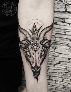 a black and white photo of a goat's head on the left arm with geometric shapes