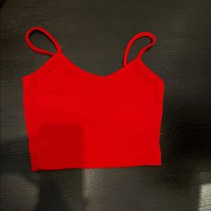 Never Worn! Red Stretch Camisole For Spring, Red Seamless Tank Top For Spring, Red Cropped Fitted Tank Top, Red Fitted Cropped Tank Top, Red Seamless Camisole Top, Casual Red Tank Crop Top, Red Fitted Casual Camisole, Red Stretch Cropped Tank Top, Stretch Red Cropped Tank Top