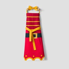 a red and yellow apron hanging on a wall