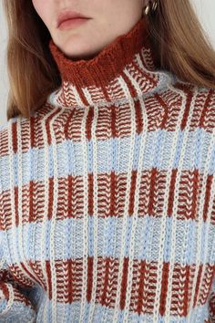 a close up of a woman wearing a sweater