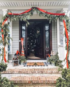 a christmas tree is on the front porch