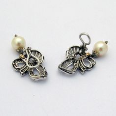 "Vintage 14 K (.585) white gold omega earrings, featuring ribbon motifs with detachable Cultured Pearl dangle sections. Earrings are decorated with 114 baguette and round cut Diamonds - approximately 3 carats total weight. Amazing craftsmanship and attention to detail. These magnificent earrings are 1 5/8\" long, 13/16\" wide and weigh a total 15.9 grams. Pearls are 10 mm in diameter. EA599" White Gold Clip-on Earrings For Anniversary, Anniversary White Gold Clip-on Earrings, Luxury Sterling Silver Clip-on Earrings For Evening, Elegant White Gold Sterling Silver Clip-on Earrings, Elegant Sterling Silver Clip-on Pearl Earrings, Luxury Wedding Earrings With Lever Back Ear Wires, Elegant Polished Pearl Earrings For Anniversary, Evening Clip-on White Gold Earrings, Luxury Silver Clip-on Pearl Earrings