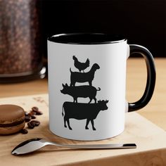 a black and white coffee mug with farm animals on it