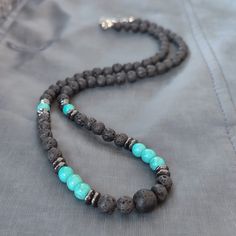 - 6mm Beaded Necklace - Welcome to our artisanal collection where craftsmanship meets nature's beauty! Dive into the essence of the ocean with our handmade Turquoise and Volcanic Lava Stone Choker Necklace, accented with Hematite beads. This exquisite piece is not just a necklace; it's a manifestation of earth's raw elegance, meticulously crafted to bring a touch of natural splendor to your attire. Handcrafted with passion and precision, this choker embodies the essence of uniqueness. Each 6mm T Meditation Jewelry With Natural Lava Stones, Lava Stone Jewelry For Meditation With Natural Stones, Round Lava Stone Beads Jewelry, Lava Stone Jewelry With Natural Round Beads, Lava Stone Jewelry With Round Natural Stones, Natural Lava Stone Round Beads Jewelry, Turquoise Beaded Necklaces With 8mm Beads For Healing, Turquoise Beaded Necklace With 8mm Beads For Healing, Bohemian Jewelry With Natural Lava Stones