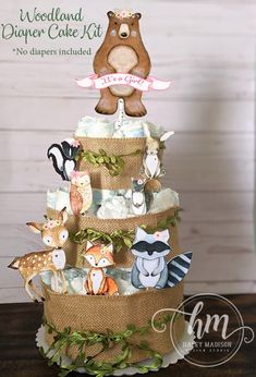 a three tiered cake decorated with woodland animals and deer figurines on top