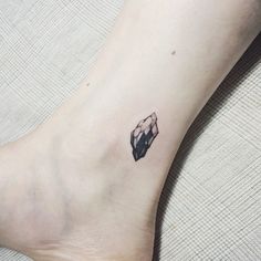 a small diamond tattoo on the ankle