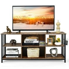 a flat screen tv sitting on top of a wooden shelf next to a bookcase