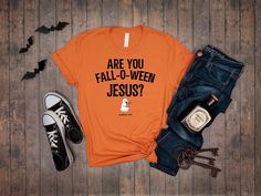 Celebrate the fall season with a touch of faith and humor in this Christian Halloween shirt! Featuring the playful phrase "Are You Fall-O-Ween Jesus?" with a cute pumpkin design, this tee is perfect for adding a lighthearted and inspirational twist to your autumn wardrobe. 🎃✝️ Whether you're at church events, fall gatherings, or just enjoying the season, this shirt is a great way to share your faith with a smile. Soft, high-quality fabric for all-day comfort Fun and inspirational Christian design for the fall season Available in various sizes for men, women, and teens Ideal for church events, fall activities, or casual wear A perfect gift for those who love faith-based humor and fall fashion 𝗛𝗢𝗪 𝗧𝗢 𝗢𝗥𝗗𝗘𝗥 𝟏. Please, Check and Review all Listing Photos. 𝟐. Select Your T-Shirt Si Christian Halloween, Fall O, Jesus Tees, Funny Pumpkins, Autumn Wardrobe, Church Events, Christian Designs, Religious Shirt, Fall Activities