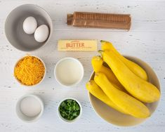 ingredients to make an egg and cheese pie laid out on a white table