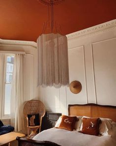 a bedroom with an orange ceiling and white walls