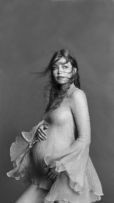 a black and white photo of a pregnant woman