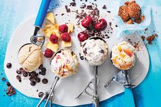 ice cream sundaes on a white plate with spoons and blue utensils