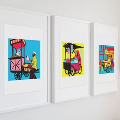 three framed pictures hanging on the wall in a room with white walls and colorful artwork