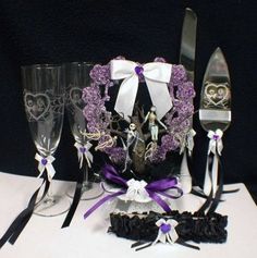 a table topped with wine glasses and silverware next to a couple of wedding garters