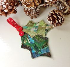 an ornament made out of fabric and pine cones