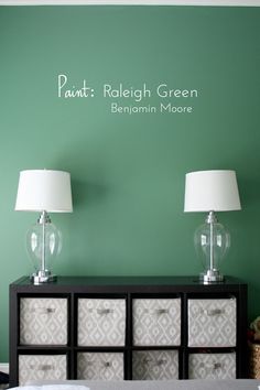 two lamps on top of a dresser next to a wall with the words paint - rhelgh green