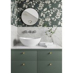 a white bowl sink sitting on top of a counter next to a wall mounted mirror