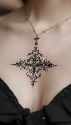 a woman's chest with an ornate cross tattoo on her left side, as if it were from the victorian era