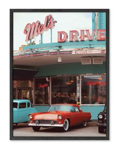 an old red car parked in front of a diner