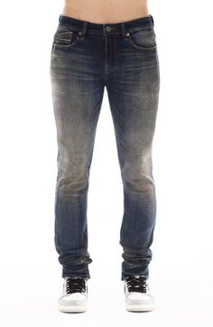 Slim-fitting stretch jeans feature a dimensional dark wash, subtle distressing and signature stitching at the back leg for an everyday edgy look. Zip fly with button closure Five-pocket style 89% cotton, 6% polyester, 5% spandex Machine wash, line dry Imported Rugged Fitted Denim Blue Bottoms, Fitted Rugged Denim Blue Bottoms, Fitted Distressed Denim Blue Jeans, Rugged Fitted Straight Leg Jeans, Distressed Fitted Medium Wash Jeans, Fitted Rugged Rigid Denim Bottoms, Distressed Fitted Jeans In Medium Wash, Rugged Fitted Denim Jeans, Fitted Faded Distressed Jeans