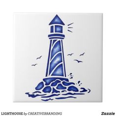 a blue and white tile with a lighthouse on it