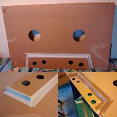 cardboard box with holes cut into it sitting on the floor