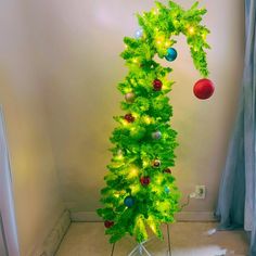 a green christmas tree with ornaments on it