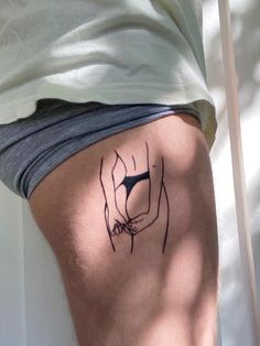 a person with a tattoo on their thigh