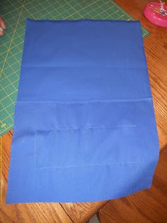 a blue piece of cloth sitting on top of a wooden table