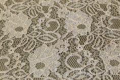 an image of a lace tablecloth with flowers on it