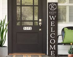 a welcome sign sitting on the front porch next to a chair and potted cacti