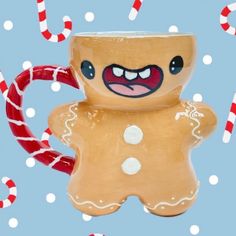 a ceramic gingerbread man with candy canes in the foreground and snowflakes in the background