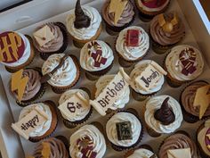 a box filled with lots of cupcakes covered in frosting