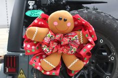 a close up of a stuffed animal on the back of a jeep with a bow