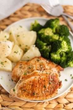 a white plate topped with chicken, potatoes and broccoli