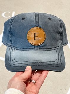 Women's Acid Washed Adjustable Baseball Cap E AND CO. CLOTHING BASEBALL CAP Introducing the E and Co. Baseball Cap: the perfect blend of signature style and casual comfort for all your summer days. Show off your love for the brand while staying cool and stylish. Upgrade your look with this must-have accessory. Take a look at our other hats and accessories HERE! Details One size Women's Acid Washed Adjustable Baseball Cap Color option: Black Acid Wash Leather patch Adjustable 100% Cotton Hats are final sale and cannot be exchanged or returned Luxury Cotton Curved Brim Baseball Cap, Trendy Flat Bill Baseball Cap For Outdoor, Adjustable Casual Snapback Hat With Leather Patch, Casual Adjustable Fitted Hat, Everyday Trucker Hat For Baseball Season With Curved Bill, Adjustable Casual Hat With Custom Logo, Casual Hats With Leather Patch, Casual Leather Patch Snapback Baseball Cap, Casual Fitted Cap With Custom Logo